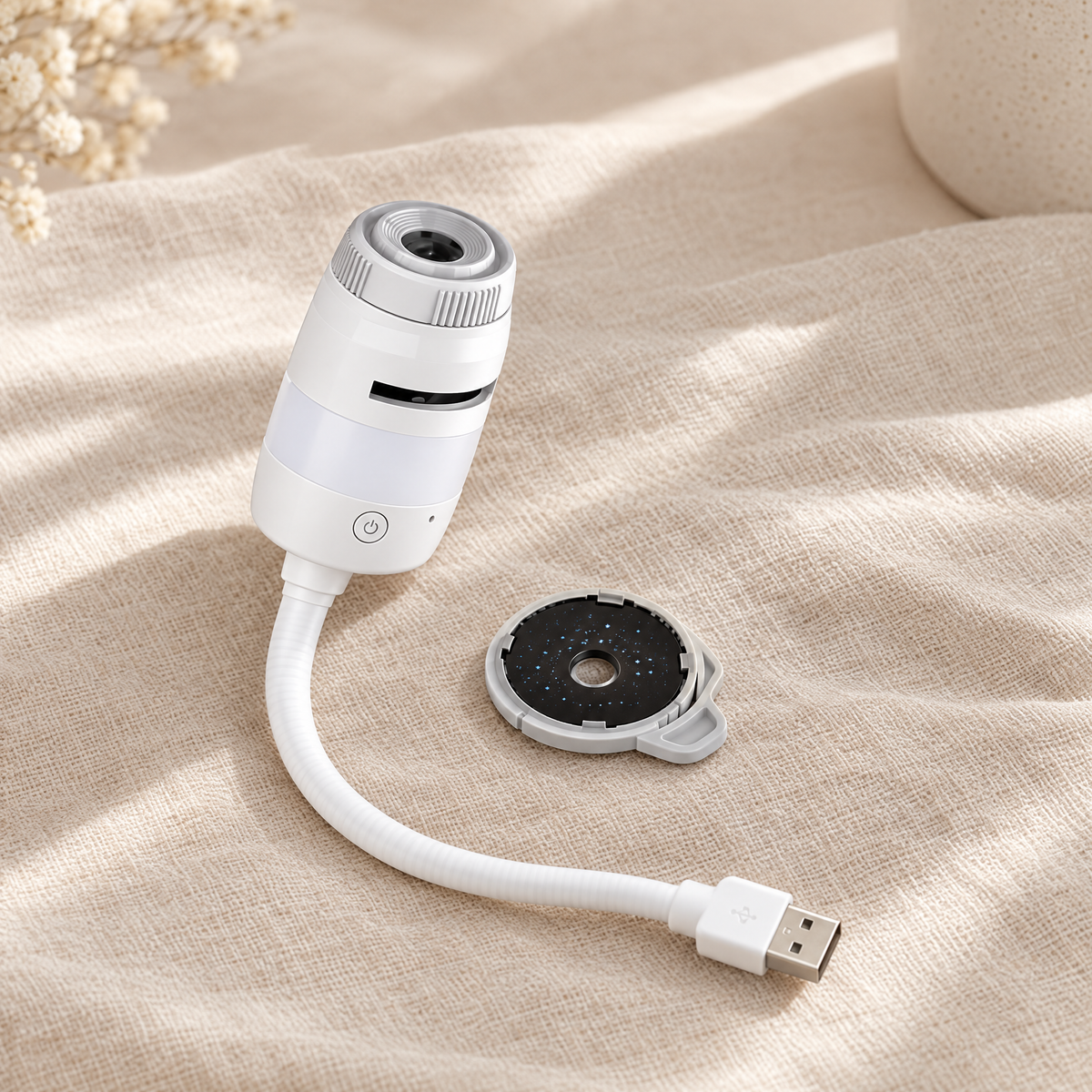 Projecteur galactique blanc à col flexible et prise USB, avec un film, posé sur du lin